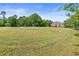 Expansive front yard leading up to a large brick two-story home surrounded by mature trees at 5360 Franklin Goldmine Rd, Cumming, GA 30028