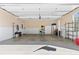 Spacious garage with epoxy floor, white cabinets, and shelving for storage and organization at 5360 Franklin Goldmine Rd, Cumming, GA 30028
