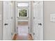 Hallway leading to a bright bathroom with a large tub at 5360 Franklin Goldmine Rd, Cumming, GA 30028