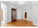 Hallway with hardwood floors and classic display cabinet at 5360 Franklin Goldmine Rd, Cumming, GA 30028