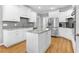 Open kitchen design featuring white cabinets, stainless steel appliances, and a functional kitchen island at 5360 Franklin Goldmine Rd, Cumming, GA 30028