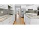 Well-equipped kitchen featuring white cabinets, stainless steel appliances, and an island with stone countertops at 5360 Franklin Goldmine Rd, Cumming, GA 30028