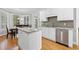 Bright eat-in kitchen with white cabinets, stainless steel appliances, and a center island with stone countertops at 5360 Franklin Goldmine Rd, Cumming, GA 30028