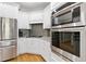 Modern kitchen featuring white cabinets, stainless steel appliances, and a built-in double oven at 5360 Franklin Goldmine Rd, Cumming, GA 30028