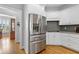 Spacious kitchen with stainless steel refrigerator and ample white cabinetry at 5360 Franklin Goldmine Rd, Cumming, GA 30028
