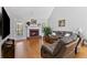 Inviting living room with hardwood floors, brick fireplace, and comfortable seating area at 5360 Franklin Goldmine Rd, Cumming, GA 30028