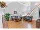 Spacious living room featuring a high ceiling, hardwood floors, and a cozy fireplace at 5360 Franklin Goldmine Rd, Cumming, GA 30028