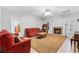 Cozy living room with a fireplace, red sofas, and neutral carpet at 5360 Franklin Goldmine Rd, Cumming, GA 30028