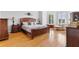 Spacious primary bedroom with hardwood floors, furniture set, and a comfortable seating area at 5360 Franklin Goldmine Rd, Cumming, GA 30028