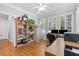 Bright home office with hardwood floors, large windows with plantation shutters, and built-in shelving at 5360 Franklin Goldmine Rd, Cumming, GA 30028