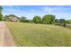 Spacious lawn featuring mature trees and a charming brick home at 5360 Franklin Goldmine Rd, Cumming, GA 30028