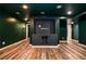 Finished basement featuring a built-in entertainment center, wood-look flooring and painted walls at 970 Winding Creek Trl, Sandy Springs, GA 30328