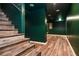 Finished basement area showcasing wood-look floors and teal painted walls and ceilings at 970 Winding Creek Trl, Sandy Springs, GA 30328