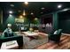Virtual staging of finished basement with furniture, featuring a built-in entertainment center at 970 Winding Creek Trl, Sandy Springs, GA 30328