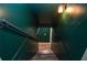 Basement staircase with a metal handrail, wood-look steps, and painted walls at 970 Winding Creek Trl, Sandy Springs, GA 30328
