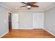 Spacious bedroom featuring hardwood floors, neutral walls, and a large closet with sliding doors at 970 Winding Creek Trl, Sandy Springs, GA 30328