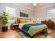 Staged bedroom with hardwood floors, neutral walls, area rug and lots of natural light at 970 Winding Creek Trl, Sandy Springs, GA 30328