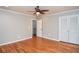 Bedroom featuring hardwood floors, neutral walls, and a large closet with sliding doors at 970 Winding Creek Trl, Sandy Springs, GA 30328