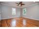 Bedroom featuring hardwood floors, neutral walls, two windows and modern ceiling fan at 970 Winding Creek Trl, Sandy Springs, GA 30328