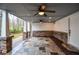 Inviting covered patio with stone accents and outdoor ceiling fans, great for relaxing at 970 Winding Creek Trl, Sandy Springs, GA 30328