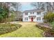 Inviting two-story home featuring classic white siding, red door, and manicured front yard at 970 Winding Creek Trl, Sandy Springs, GA 30328