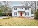 Attractive two-story white home with a red front door and a covered parking area at 970 Winding Creek Trl, Sandy Springs, GA 30328