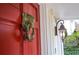 Close-up of the front door featuring a unique lion head knocker and classic exterior lighting at 970 Winding Creek Trl, Sandy Springs, GA 30328