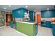 A gourmet kitchen boasting a green island and blue cabinets, complemented by a geometric tile floor at 970 Winding Creek Trl, Sandy Springs, GA 30328