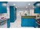 Spacious kitchen with sleek blue cabinets, modern appliances, pantry and an island with views to the dining area at 970 Winding Creek Trl, Sandy Springs, GA 30328
