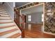 Living room with hardwood floors and adjacent staircase and custom wallpaper at 970 Winding Creek Trl, Sandy Springs, GA 30328