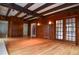 Living room with wood paneling, beamed ceiling, multiple access points, and natural light at 970 Winding Creek Trl, Sandy Springs, GA 30328
