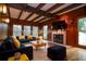 Staged living room with wood paneling, beamed ceiling, fireplace, and comfortable seating at 970 Winding Creek Trl, Sandy Springs, GA 30328