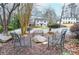 Cozy outdoor seating area with metal chairs and a stone fire pit, perfect for gatherings at 970 Winding Creek Trl, Sandy Springs, GA 30328
