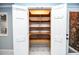Well-lit pantry with adjustable wooden shelving and easy access to the kitchen at 970 Winding Creek Trl, Sandy Springs, GA 30328