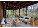 Inviting outdoor living space on a spacious wooden porch with comfortable seating and scenic woodland views at 970 Winding Creek Trl, Sandy Springs, GA 30328