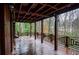 Expansive covered wooden porch featuring intricate railings and forest views provides a perfect outdoor retreat at 970 Winding Creek Trl, Sandy Springs, GA 30328