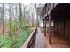 Elevated wooden porch with wood and stone supports showcases views of the deck and surrounding landscape at 970 Winding Creek Trl, Sandy Springs, GA 30328