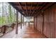 Elevated wooden porch with wood and stone supports showcases long views of the deck and landscaping at 970 Winding Creek Trl, Sandy Springs, GA 30328