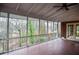 Large screened porch with wood floor, bright white ceiling and views to the wooded outdoors at 970 Winding Creek Trl, Sandy Springs, GA 30328