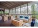 Cozy screened porch offers comfortable wicker seating and a tranquil view of the surrounding wooded landscape at 970 Winding Creek Trl, Sandy Springs, GA 30328