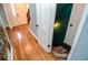 Staircase leading to the upper level, complemented by an open door and hardwood floors at 970 Winding Creek Trl, Sandy Springs, GA 30328