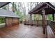 Wooden deck with pergola, built-in seating and views to the wooded surroundings at 970 Winding Creek Trl, Sandy Springs, GA 30328