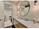 Bathroom showcasing marble countertop vanity with stylish lighting and a view into a secondary space at 2305 Braselton Hwy, Buford, GA 30519