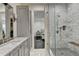 Bathroom features marble countertops, stylish fixtures, a glass-enclosed shower, and wood floors at 2305 Braselton Hwy, Buford, GA 30519