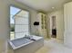 Bright bathroom with a large window overlooking the front lawn, and free standing tub at 2305 Braselton Hwy, Buford, GA 30519