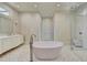 Modern bathroom featuring a soaking tub, glass shower, and double vanity with marble counters at 2305 Braselton Hwy, Buford, GA 30519