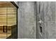 Modern bathroom with grey marble tile and glass enclosed sauna at 2305 Braselton Hwy, Buford, GA 30519