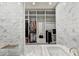 Modern bathroom boasts marble tile, walk-in closet, and luxurious soaking tub at 2305 Braselton Hwy, Buford, GA 30519