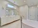 Modern bathroom with soaking tub, double vanity, and decorative tile walls at 2305 Braselton Hwy, Buford, GA 30519