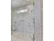 Glass enclosed shower with marble walls, shower head, and recessed niche at 2305 Braselton Hwy, Buford, GA 30519
